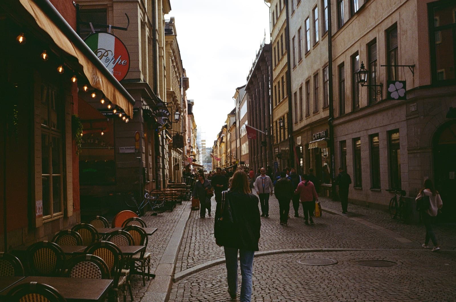 A cobbled shopping street lined with cafés
