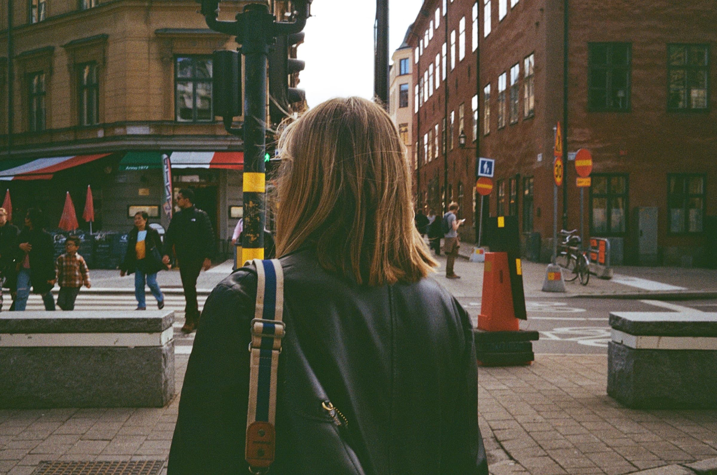 Someone walking through a busy city street, shot on film